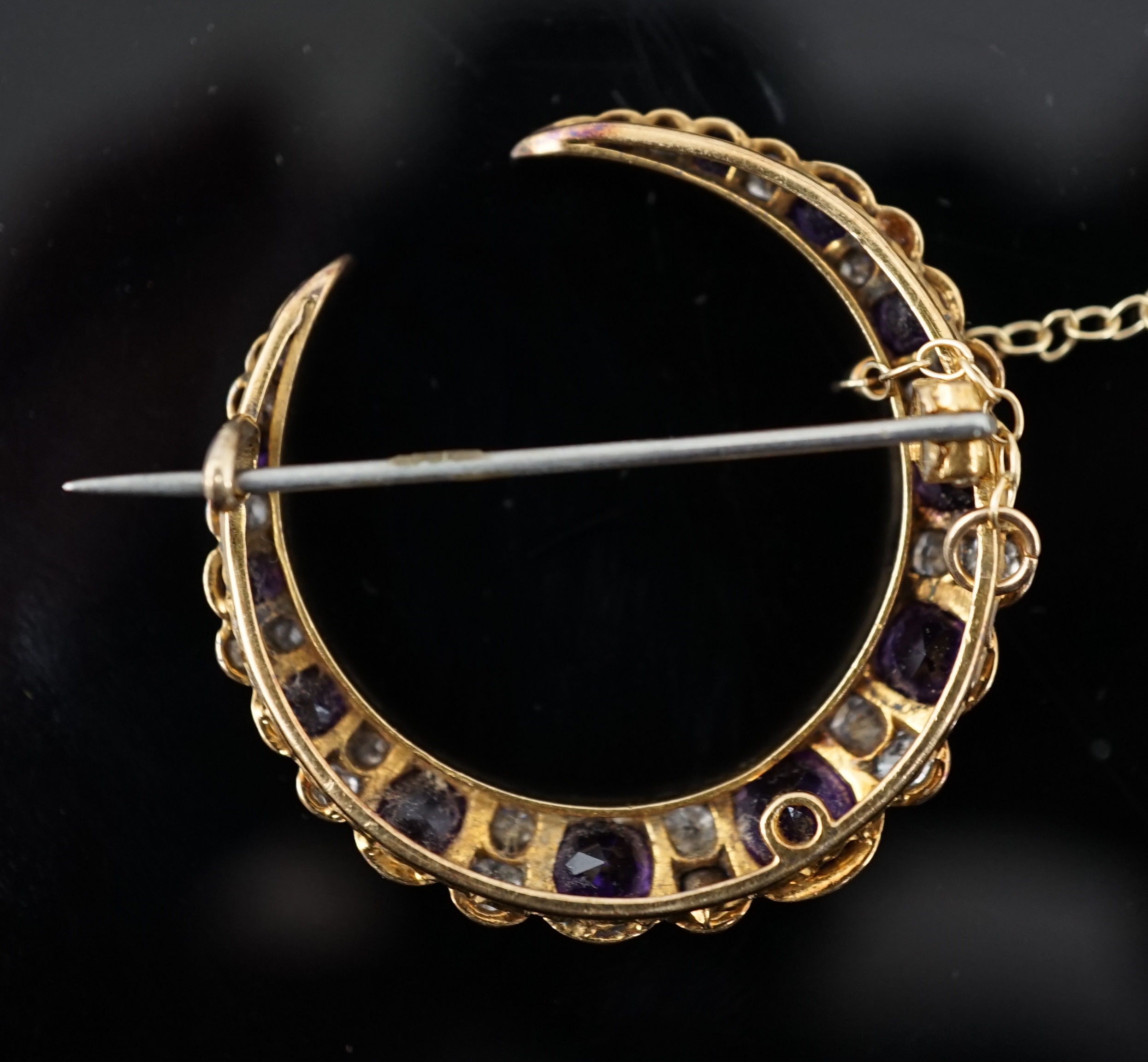 A late Victorian gold, graduated amethyst and diamond cluster set crescent brooch